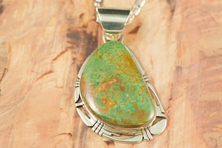 Genuine Crow Springs Turquoise set in Sterling Silver Pendant. Created by Navajo Artist Phillip Sanchez. Signed. The Crow Springs Mine is located near Tonopah, Nevada. Free 18 inch Sterling Silver Chain with purchase.
